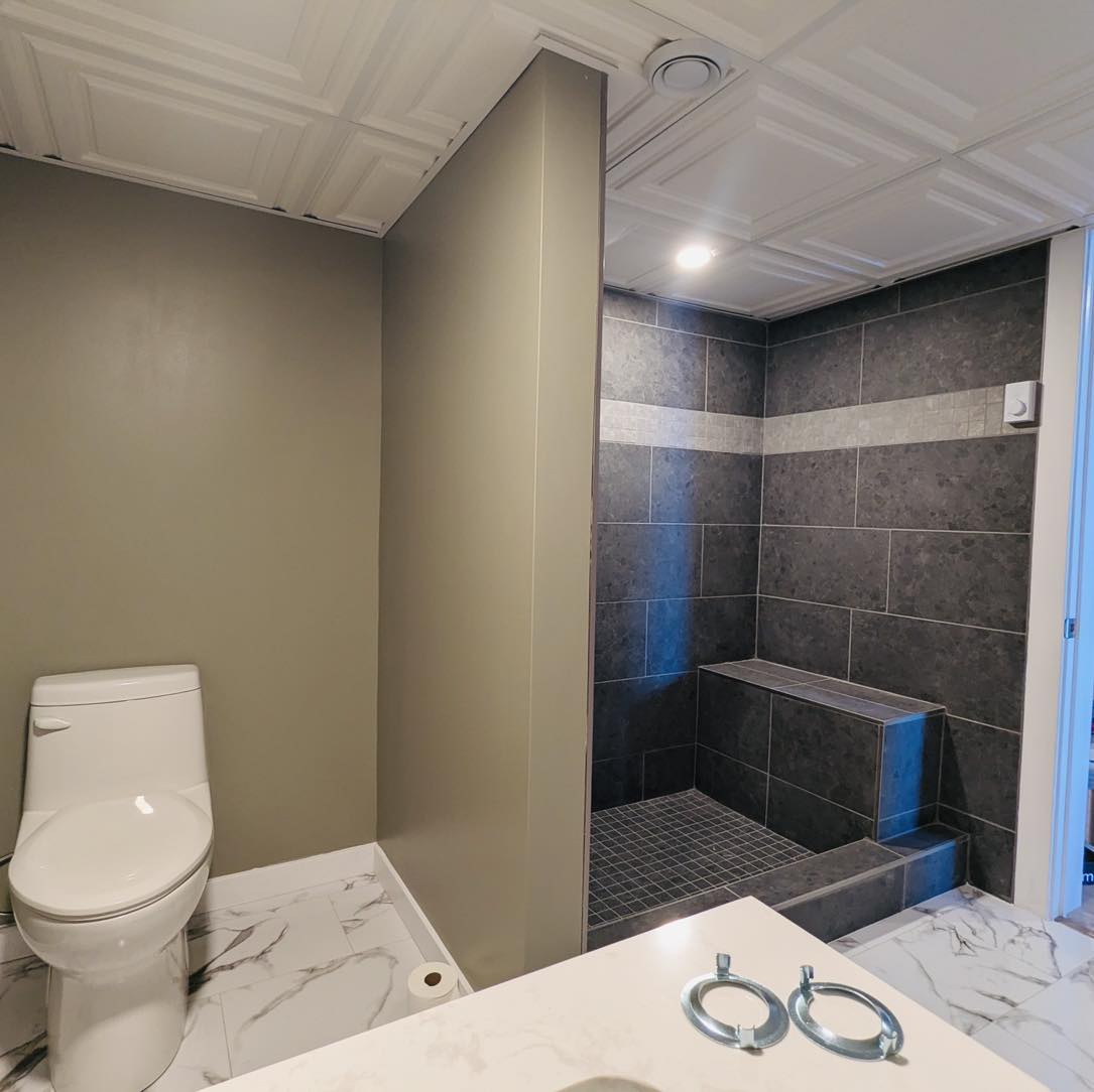 Luxury bathroom renovation featuring marble countertops and modern fixtures